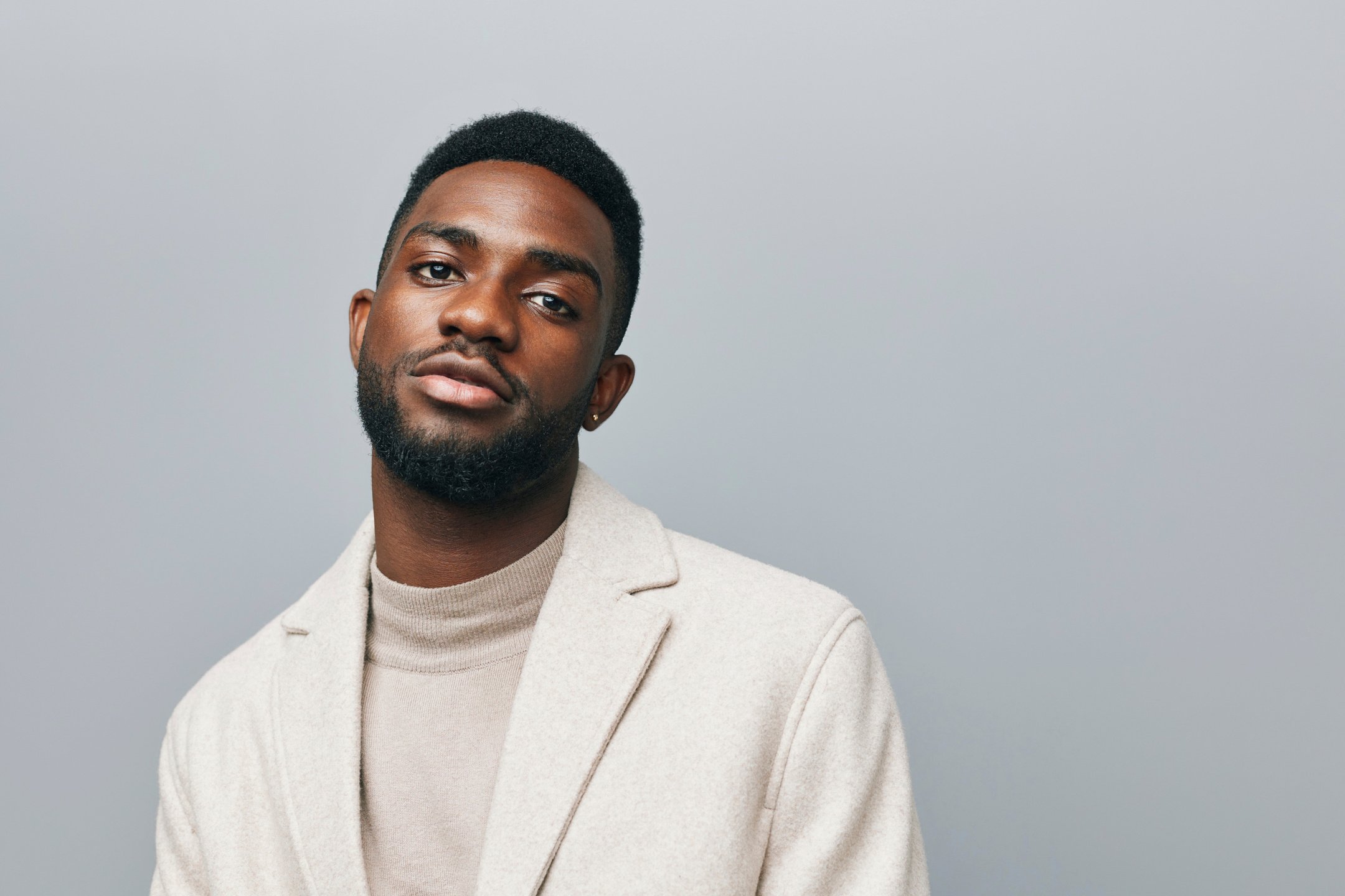 Happy Young African American Gen Z Guy Isolated on Beige Backgro